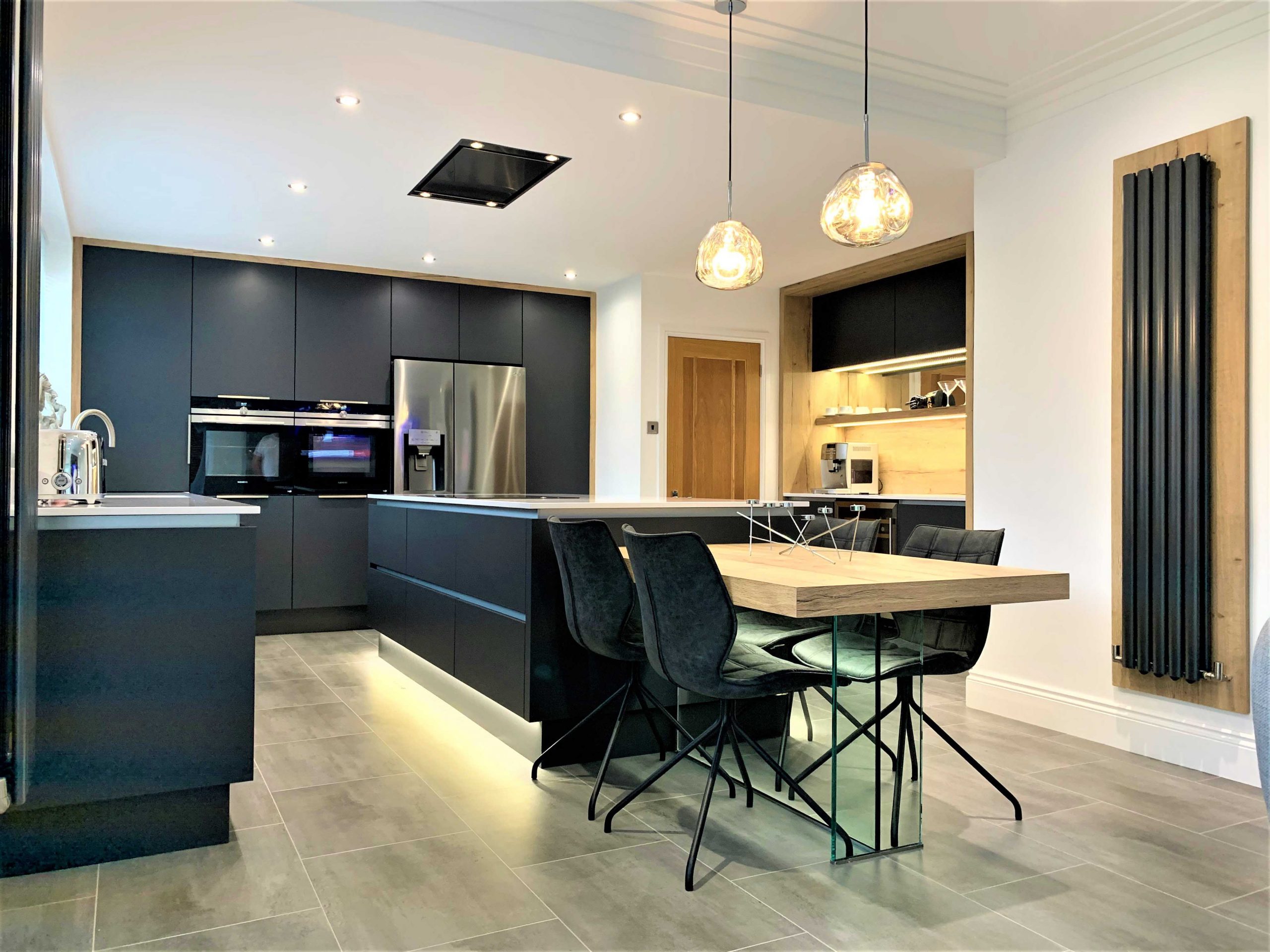 contemporary kitchen with island featuring bar furniture and integrated dining table