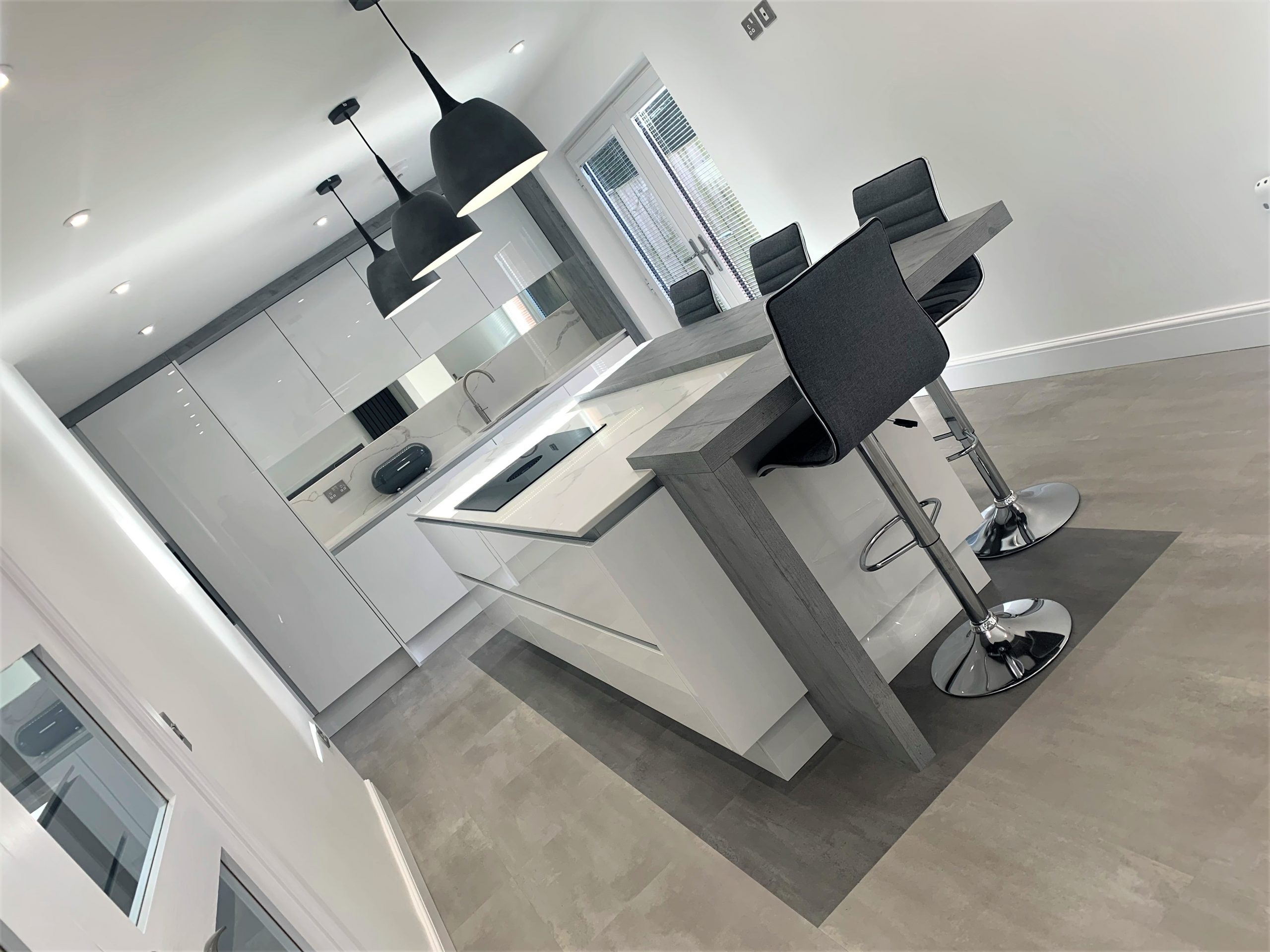 Monochromatic Finishes Minimalist Breakfasting and Dining Kitchen