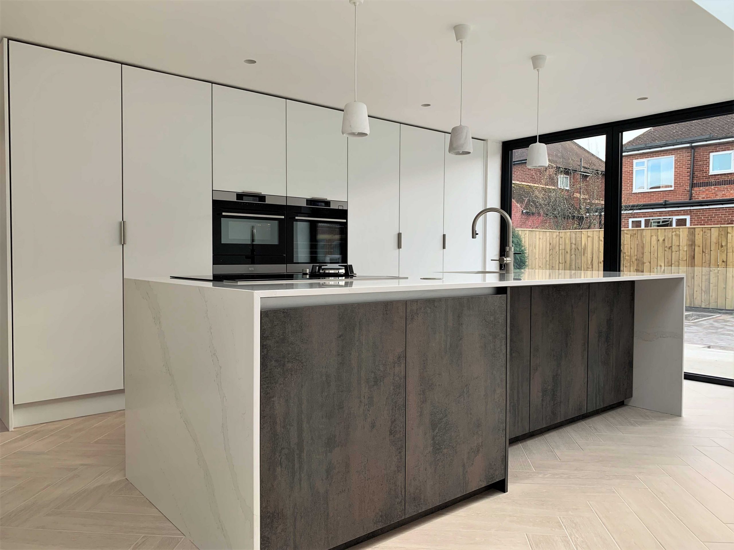 minimalist kitchen with butlers pantry and waterfall island