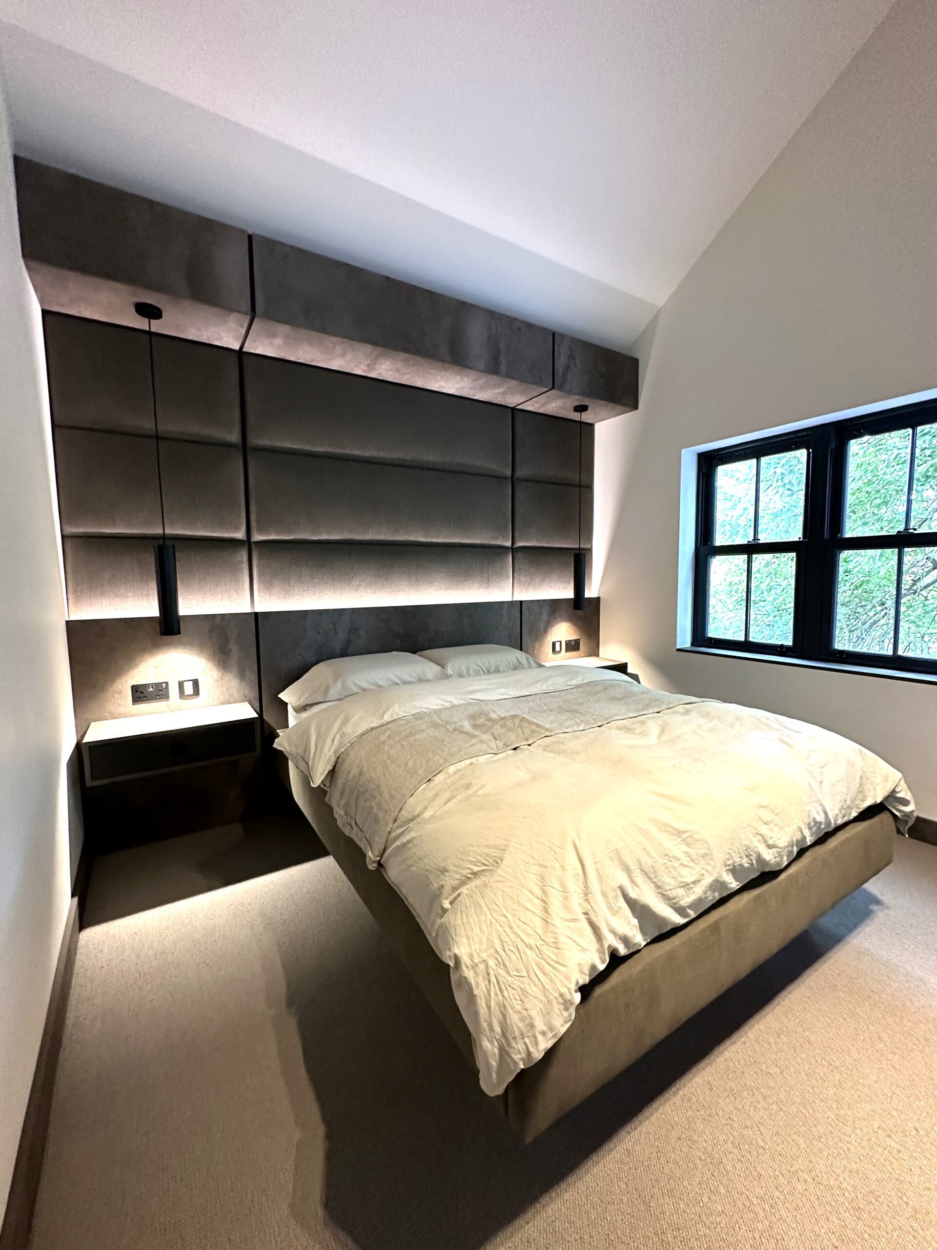 guest bedroom with feature headboard dressing table and media furniture